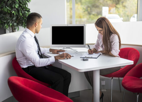 front-view-car-dealer-sellers-office-doing-paper-work